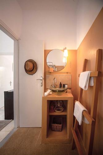 a bathroom with a sink and a mirror at New! Paxosblue suites sea view with private pool in Gaios