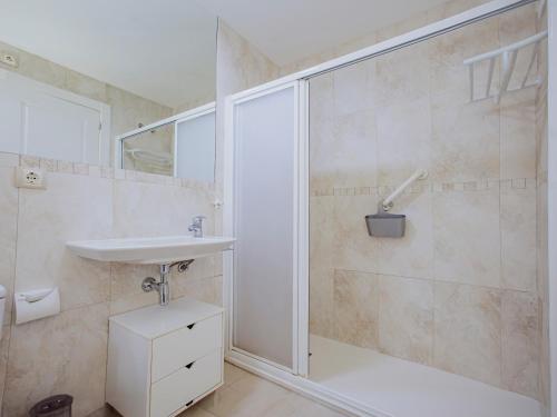 a bathroom with a sink and a glass shower at Apartamento Gema Gemelos 26 in Benidorm