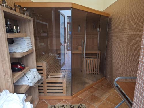 a shower with a glass door in a room at Dimora Charleston Lecce parcheggio privato in loco gratis in Lecce