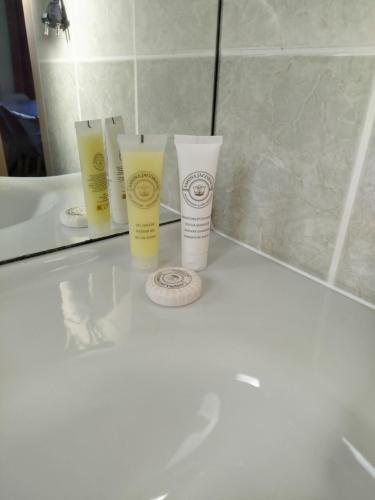 a group of three products sitting on a bathroom counter at Chez Louis in Levernois