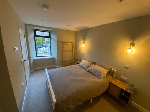 a bedroom with a large bed and a window at St Magnus Retreat in Lerwick