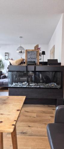 a large aquarium in a living room with a table at Appartements Familie Eberharter in Finkenberg
