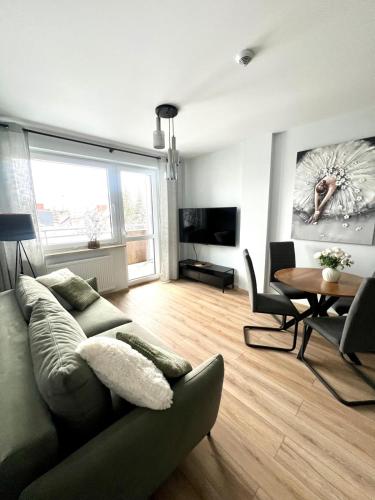 a living room with a couch and a table at SPV Rentals Pileckiego 59 lokal 226 free Parking Ursynów in Warsaw