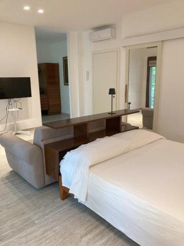 a bedroom with a large bed and a couch at Serena a due passi dal mare in Bellaria-Igea Marina