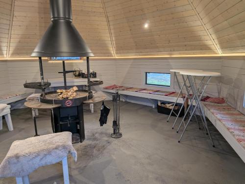 a room with a stove and a table and a desk at Matkailumaja Heikkala Cottages in Ruka