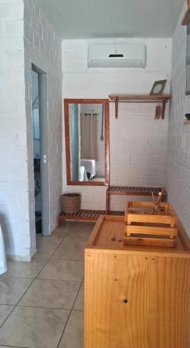 a room with a mirror and a wooden box at POUSADA ALLES in Santo Amaro