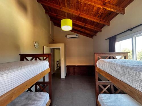 a room with two beds and a window at Alma Apart in Los Molles
