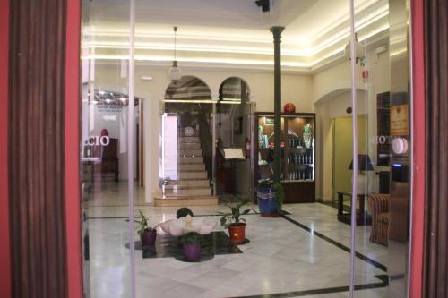 a person sitting on the floor in a lobby at Hotel Palacio de Oñate in Guadix