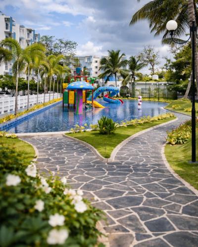 a pool with a water park in a city at Rizz Santorini Apartment in Negombo