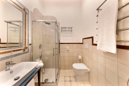 a bathroom with a toilet sink and a shower at Rosa Magra Guest House in Sorrento