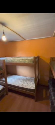 a bedroom with two bunk beds in a room at Hostel del Barranco in La Pedrera