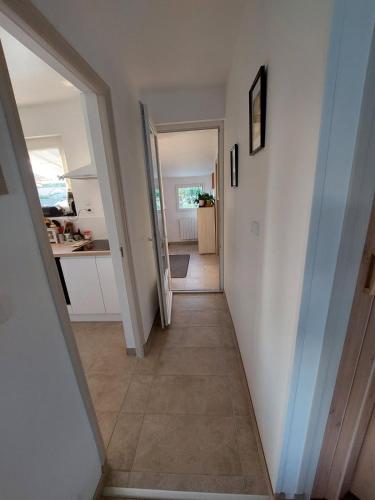 a hallway leading to a kitchen with a hallway leading to a room at Le rendez-vous des 2 amants in Romilly-sur-Andelle