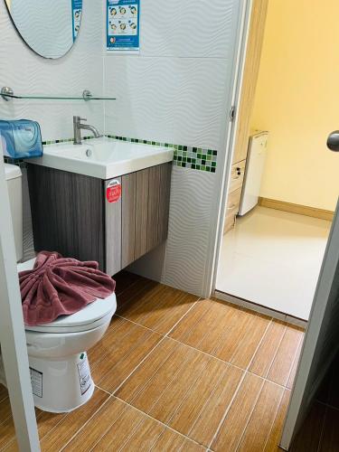 a bathroom with a toilet and a sink and a shower at Koh Yao Modern Inn -SHA Plus in Ko Yao Yai