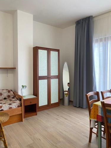 a bedroom with a bed and a table and a mirror at BM Flowers in Tropea