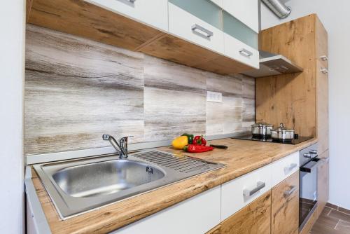 a kitchen with a sink and a wooden counter top at David in Mali Lošinj