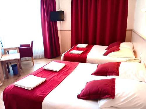 two beds in a hotel room with red curtains at Logis Hôtel Restaurant Le Palous in Baraqueville
