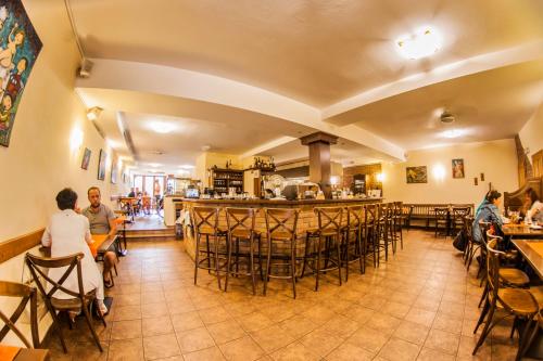 a restaurant with people sitting at tables and a bar at Penzion Černej pták in Jindřichŭv Hradec