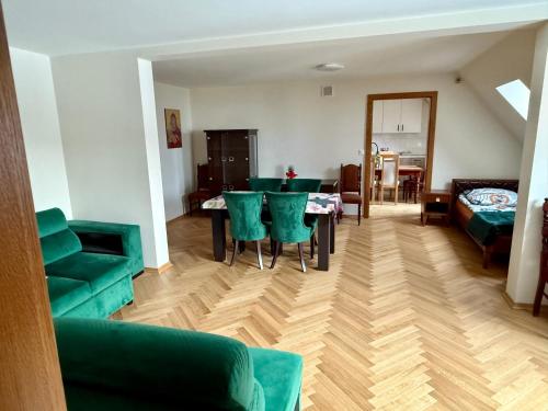 a living room with a couch and a table and chairs at Peter House in Nowy Targ