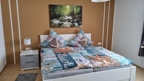 a bedroom with a bed with a comforter and pillows at Schöne 2-Zimmer Ferienwohnung in Löffingen