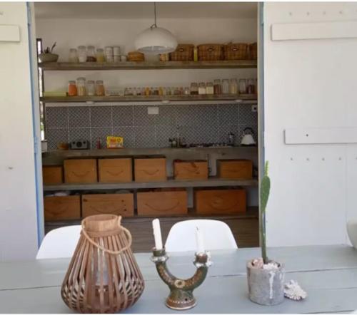 a kitchen with a table with a vase and a chair at Filao villa in Riambel