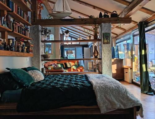 a bedroom with a large bed and a living room at ROSE ROOM for 4 guests in green Rose resort Ljubljana in Ljubljana