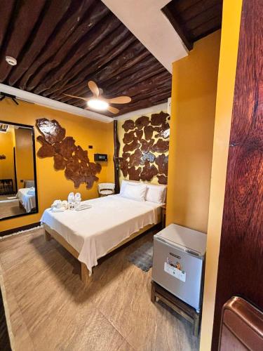 a bedroom with a large bed in a room at BING-VICE Tourist Inn in San Vicente