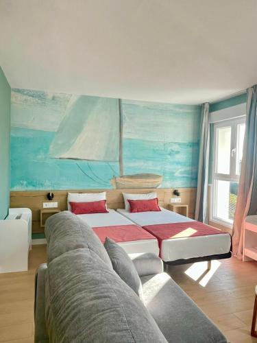a bedroom with two beds and a couch at Luxury Singular Apartments Padrón in Padrón