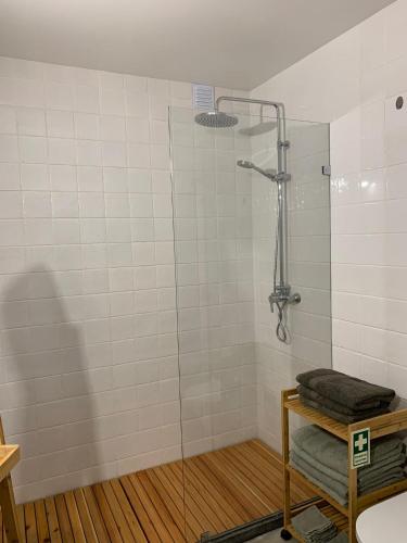 a shower with a glass door in a bathroom at Casa Picobello in Calheta de Nesquim