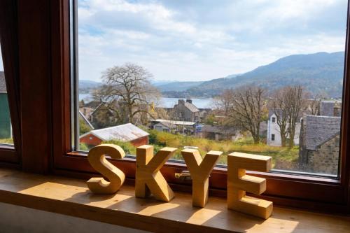 a wooden sign sitting on a window sill at Misty Isles View in Portree