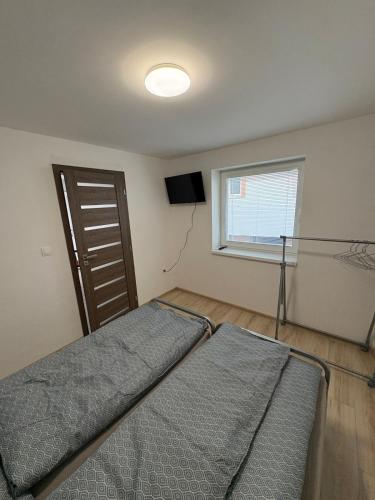a bedroom with a bed and a window at Apartman pri kostole in Krásno nad Kysucou
