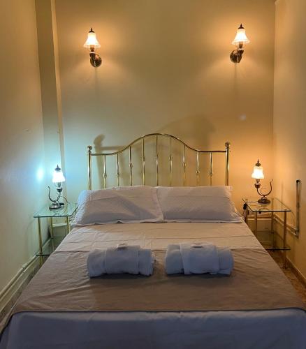 a bedroom with a bed with two pillows on it at Appart Hotel Garay in Rafaela