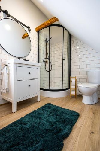 a bathroom with a sink toilet and a mirror at DOM na konci in Kostolné