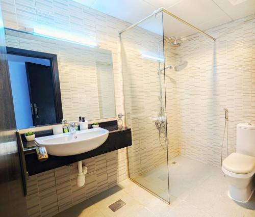 a bathroom with a sink and a shower and a toilet at Family Friendly Villa in Abu Dhabi