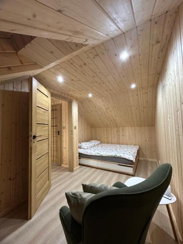 a bedroom with a bed and a couch in a room at Mazurski Chill House in Małkinie