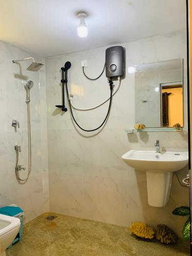 a bathroom with a shower and a sink at D2 Villa in Tangalle
