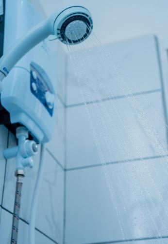 a shower head on the side of a wall at AG Comfort Homes in Nkunjila
