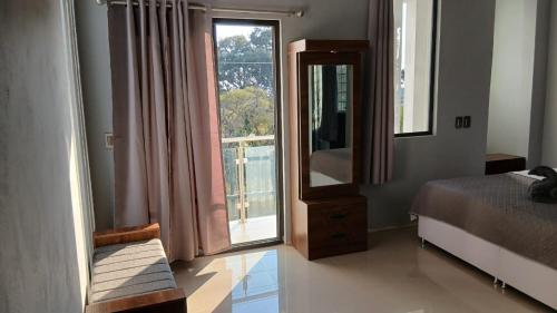 a bedroom with a mirror and a bed and a window at Cuarto en casa de campo in Arandas