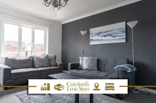 a living room with a couch and a table at Ferguson House in Airdrie