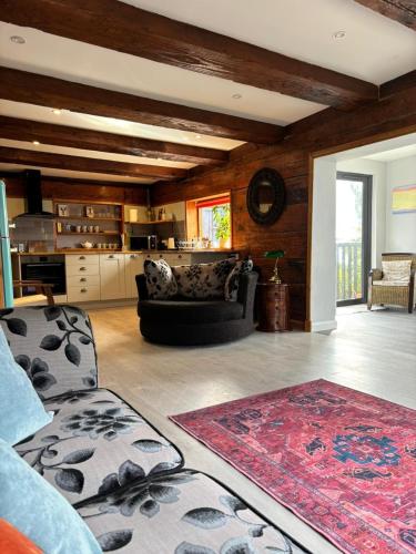 a living room with a couch and a rug at Cosy coastal hideaway with incredible sea views in Fortrose