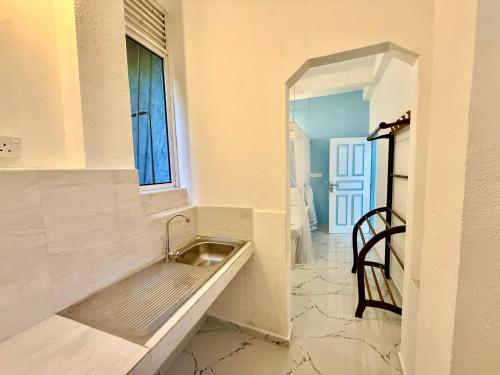 a sink in a room with a window at Shells Unawatuna in Unawatuna