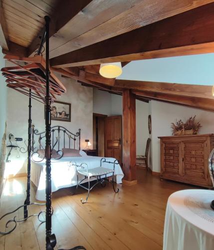a bedroom with a bed and a wooden ceiling at Apartamentos El Caballar in Sandoñana
