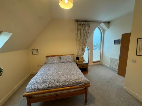 a bedroom with a bed and a large window at Turfhill House in New Deer