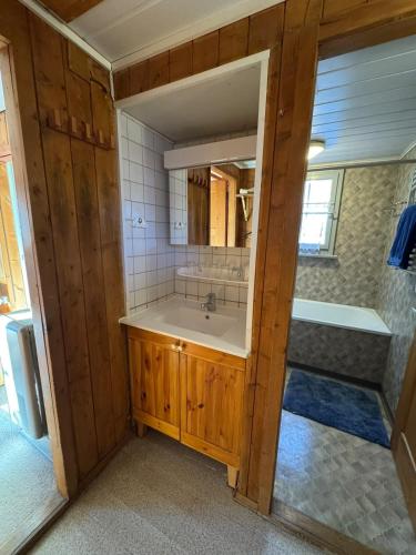 a bathroom with a sink and a mirror at Charming Chalet Silvretta in Flumserberg in Flums