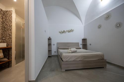 a bedroom with a bed in a white room at La Lanterna in Giovinazzo