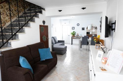 a living room with a couch and a staircase at Casa 'Saudade' in Moura