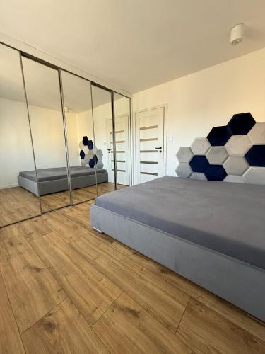 a bedroom with a large bed with blue and white pillows at AgA in Pobierowo