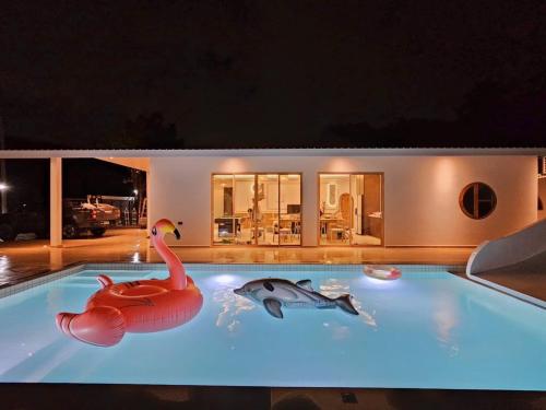 a swimming pool with a swan and a turtle on it at De Beach pool villa เดิน 3 นาทีจากชายหาด in Jomtien Beach