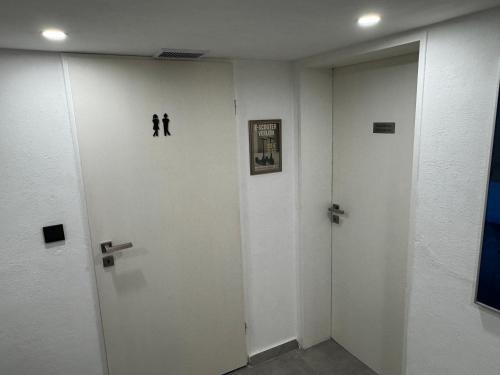 a hallway with two people on the wall at Gemütliches Kellerzimmer + Bad in Bocholt