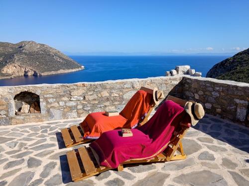 a couple of lounge chairs sitting on top of a wall at Armaki in Páliros