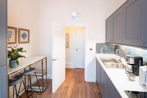 a kitchen with a sink and a counter at Stylish Retreat in Central Lyme Regis Sleeps 2 plus one in Lyme Regis